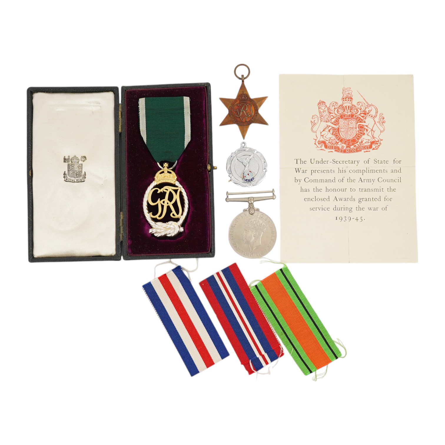 A WWII Defence medal and The France and Germany Star together with a cased Royal Navy Reserve Decoration, plus a Royal Air Force Association medallion, (4). Condition - fair to good.